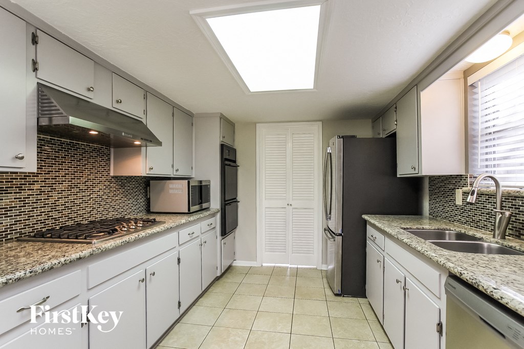 A kitchen with a skylight above the counter.
