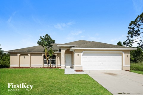 a house with a white garage door and a lawn