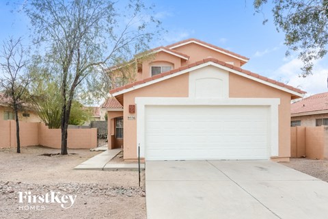 a home with a white garage door in front of it