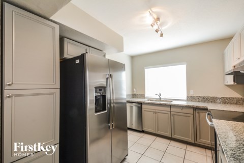 the kitchen has stainless steel appliances and granite counters