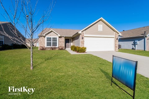 a house with a blue sign in front of it