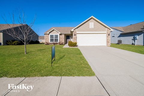 a home with a white garage door and a driveway