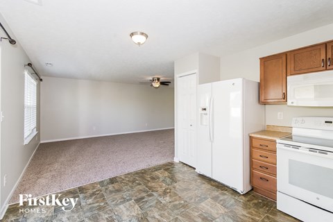 a kitchen with white appliances and wood cabinets