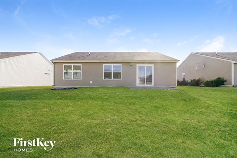the exterior of a home with a large grassy yard