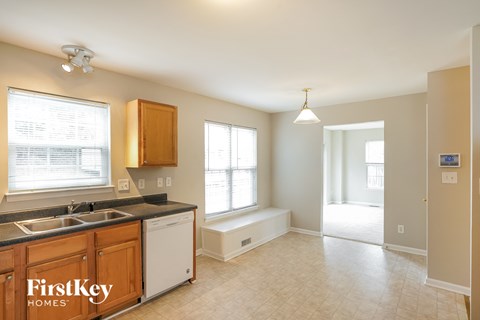A kitchen with wooden cabinets and a sink is shown.