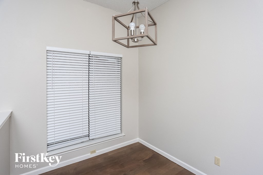 a living room with a window and a chandelier