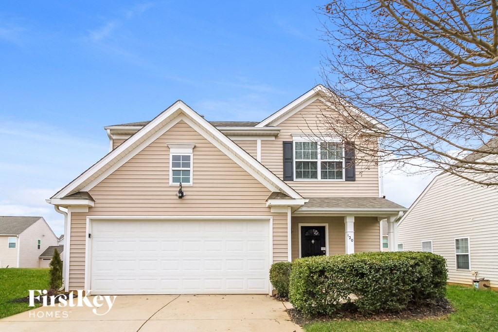 A two-story house with a garage is for sale.