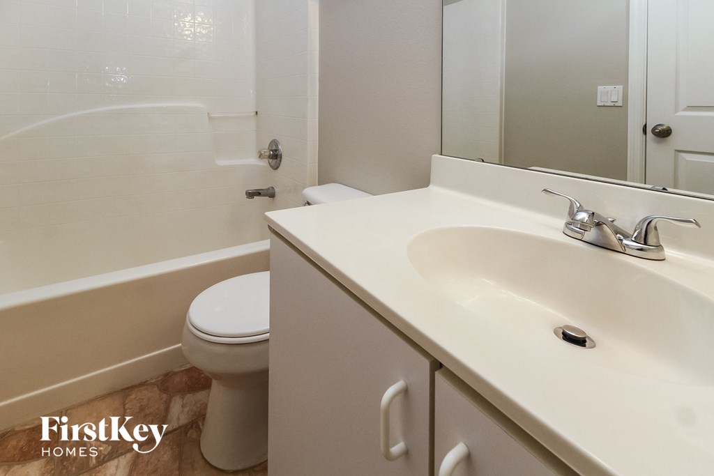 a bathroom with a sink and a toilet and a shower