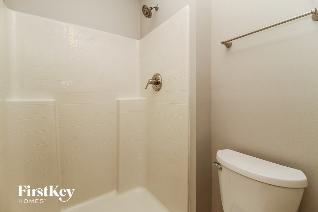 a small bathroom with a toilet and a shower