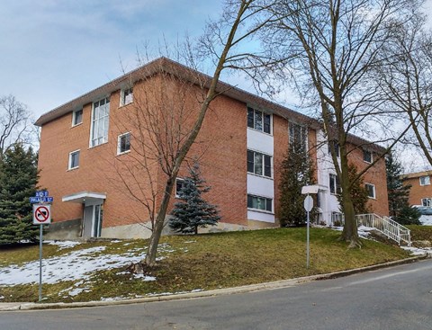 a brick apartment building on the side of a street