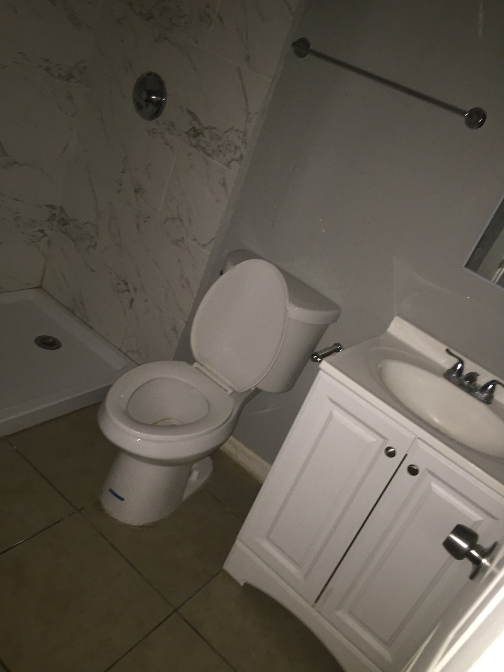 a white bathroom with a toilet and a sink