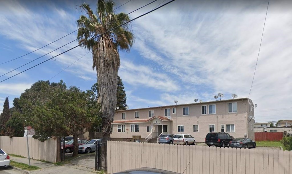 a large building with a palm tree in front of it