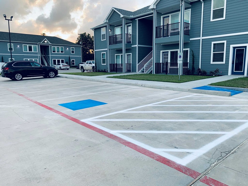 an empty parking lot in front of an apartment building