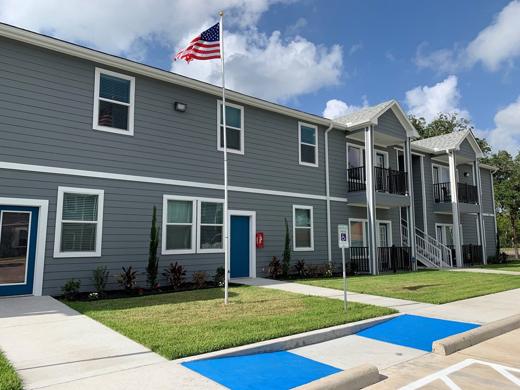 an flag flying in front of an apartment building
