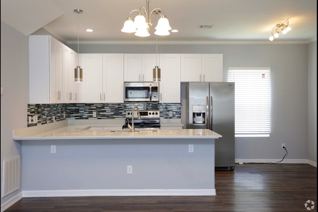 a kitchen with white cabinets and a counter top