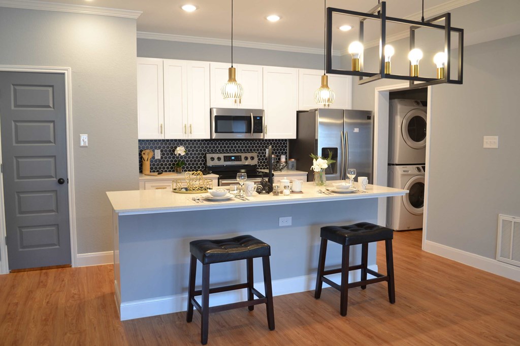 a kitchen with an island and a washing machine