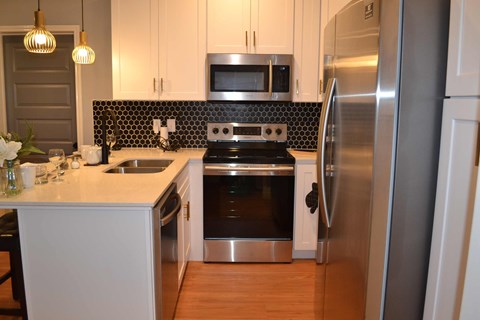 a kitchen with stainless steel appliances and white cabinets