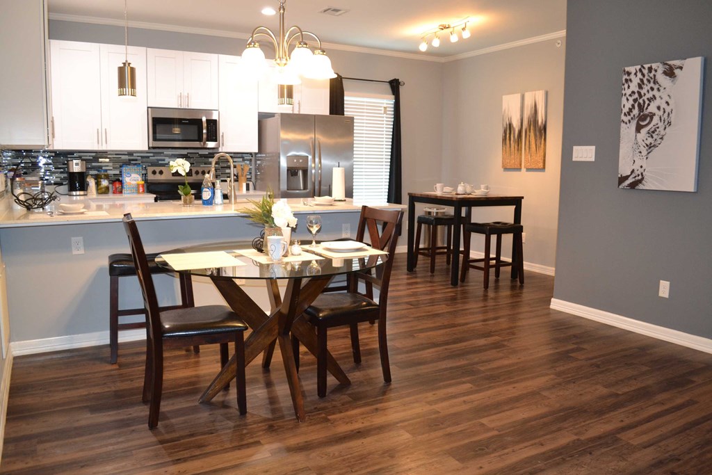 an open kitchen and dining room with a table and chairs