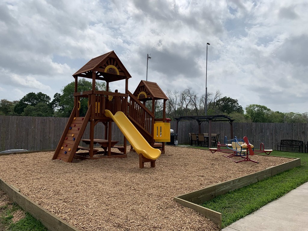 a playground with a swing set and a slide