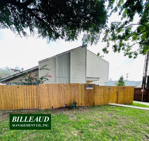 a house is behind a wooden fence