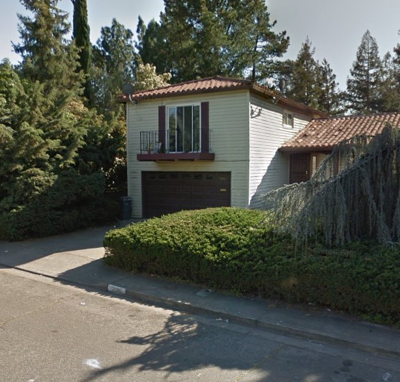 A house with a red tile roof and a garage door.