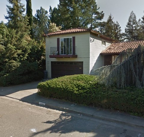 A house with a red tile roof and a garage door.