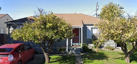 a house with a red car parked in front of it