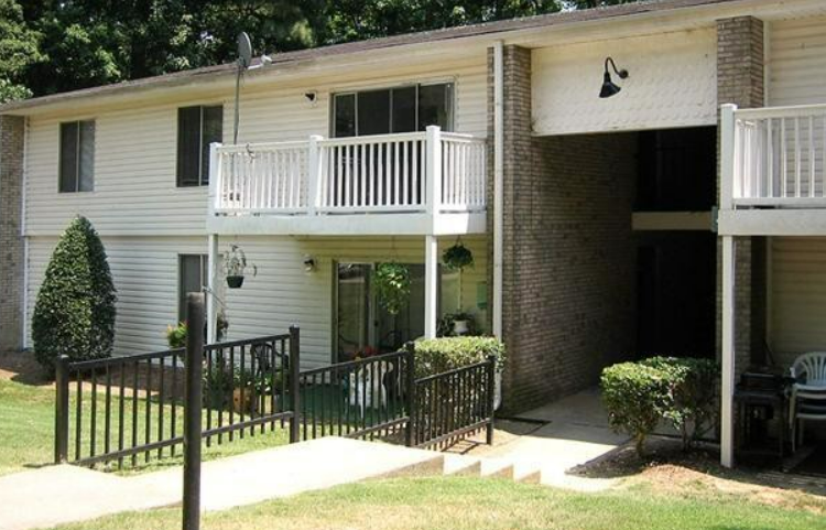 a white house with a porch and a balcony