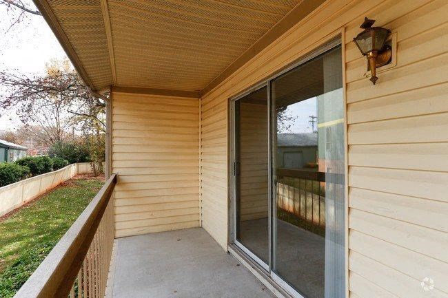 a porch of a house with a large glass door