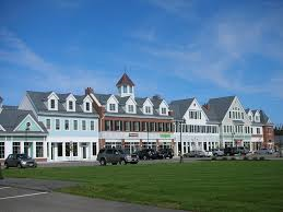 a row of houses with cars parked in front of them