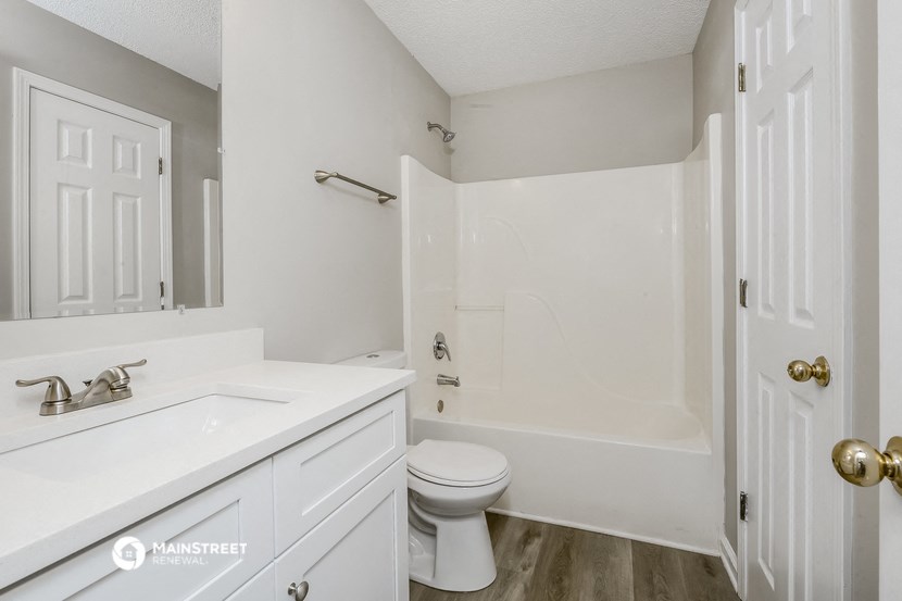 a bathroom with a sink and a toilet and a shower