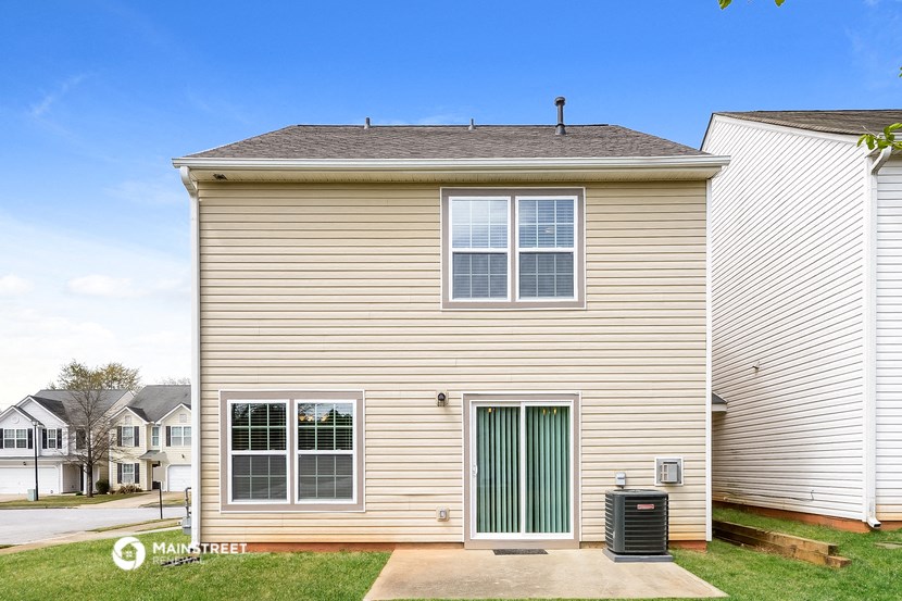 a side view of a house with a green door