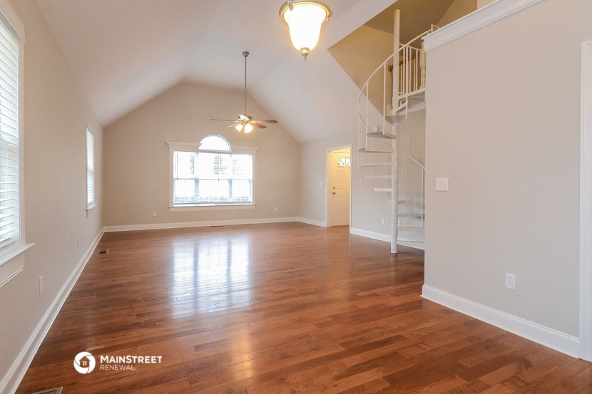 the living room and dining room of an empty house