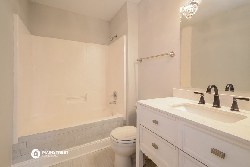 a bathroom with a sink and a toilet and a bath tub