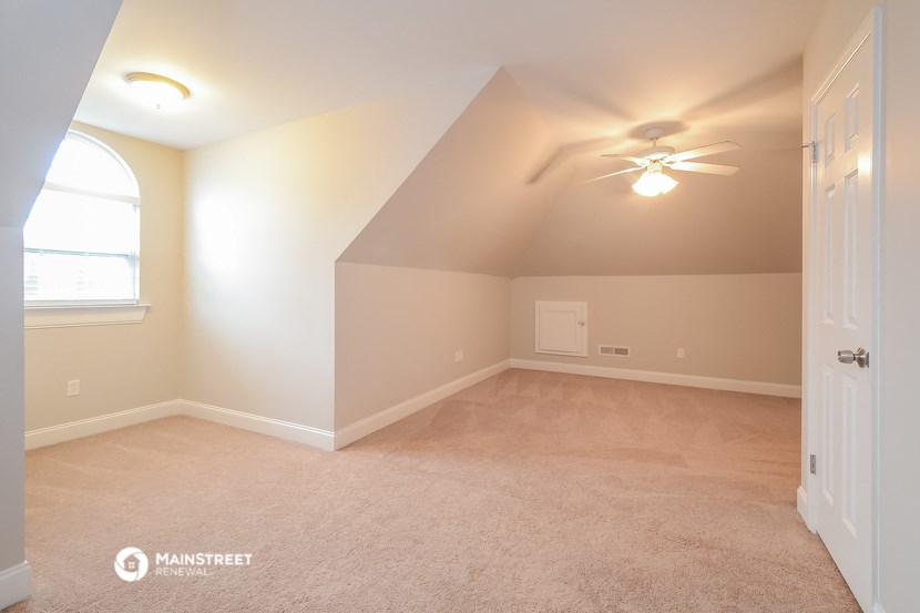 the master bedroom is spacious and updated with a ceiling fan