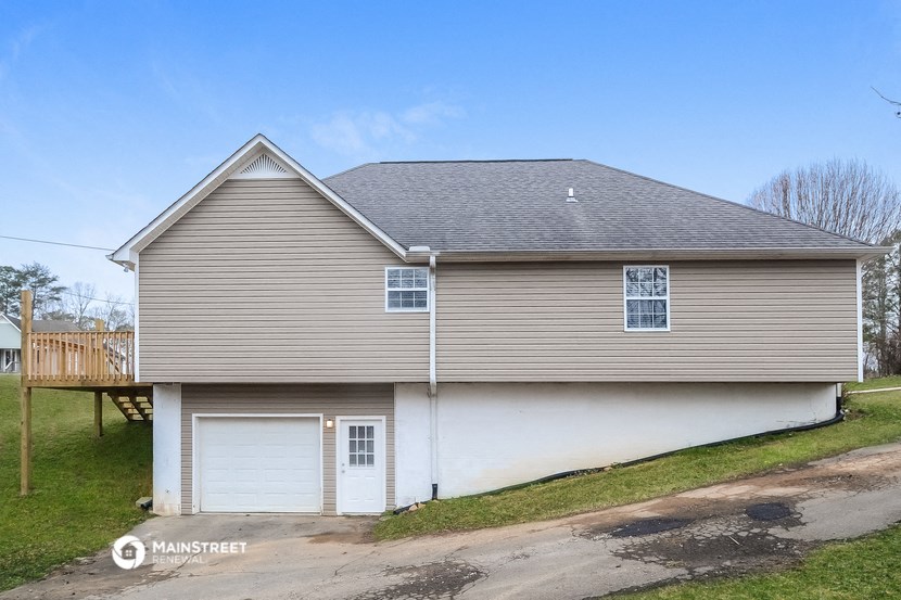 the front of a house with a white garage door