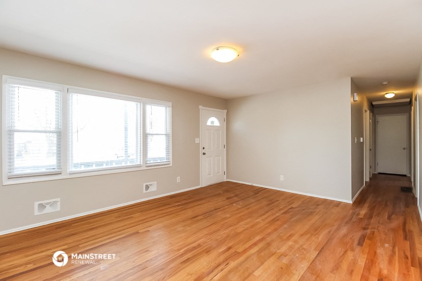 the living room and dining room with hardwood flooring