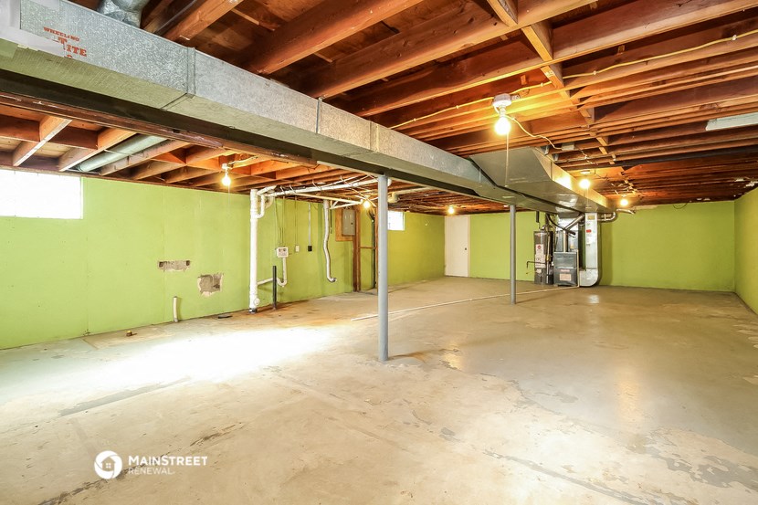 a large garage with a concrete floor and green walls