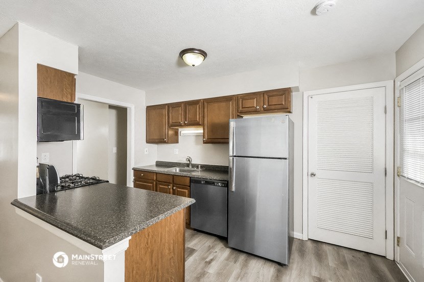 a kitchen with stainless steel appliances and granite counter tops