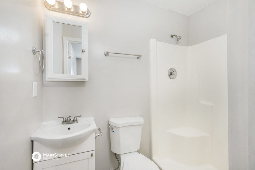 a bathroom with a sink toilet and a shower