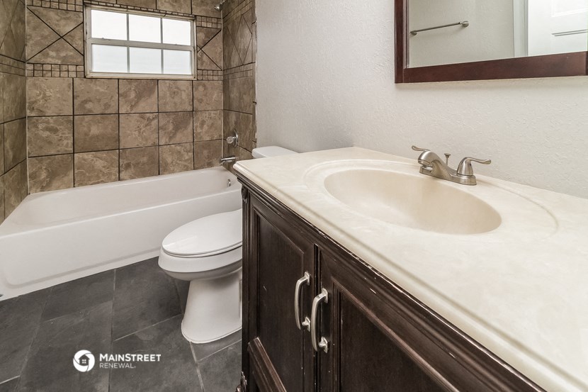 a bathroom with a sink and a toilet and a tub