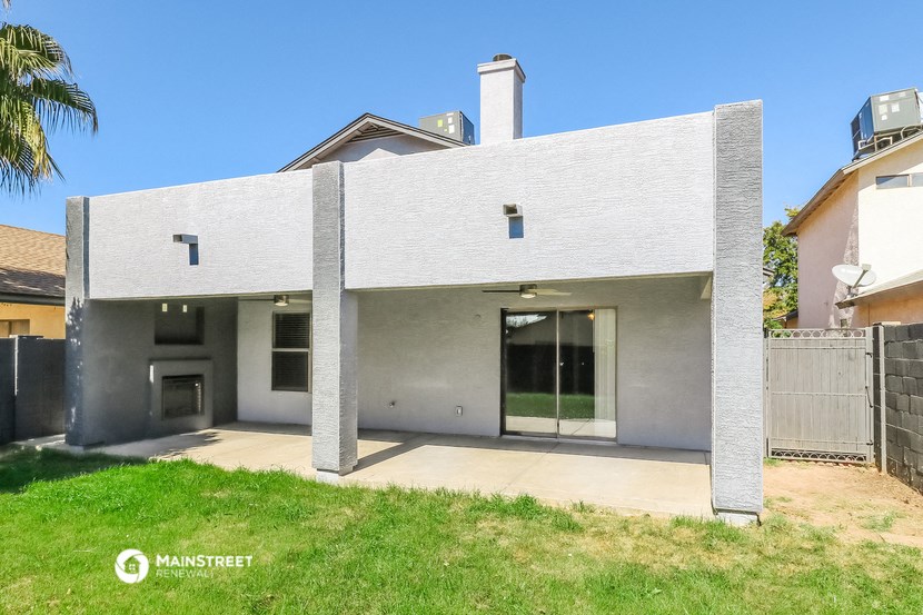 a white house with a yard in front of it