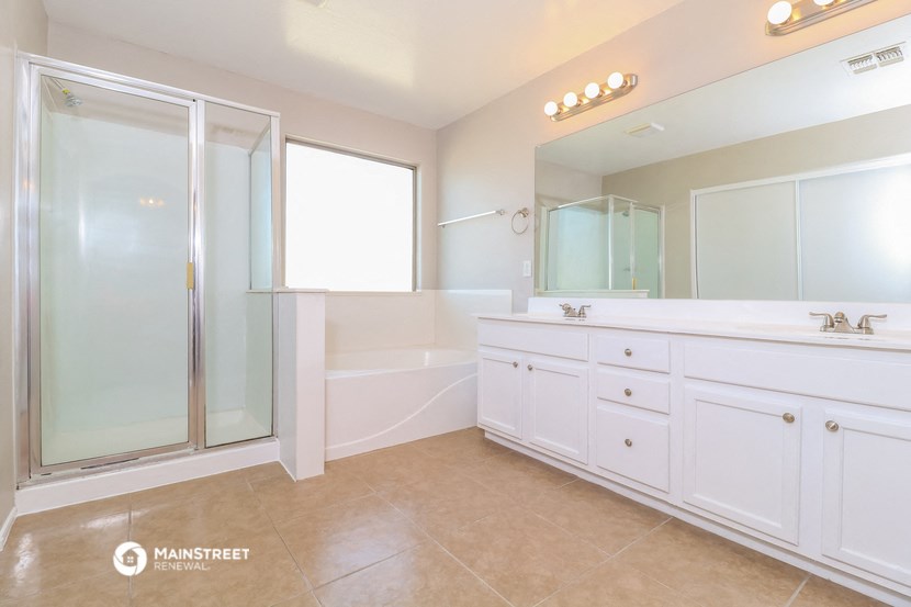a large white bathroom with a shower and a sink