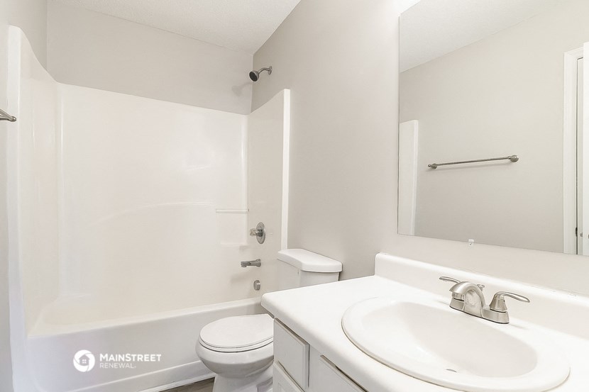 a bathroom with a sink and a toilet and a shower