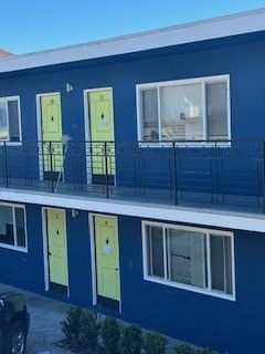 A blue building with yellow doors and windows.