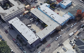 an aerial view of an old building with a parking lot