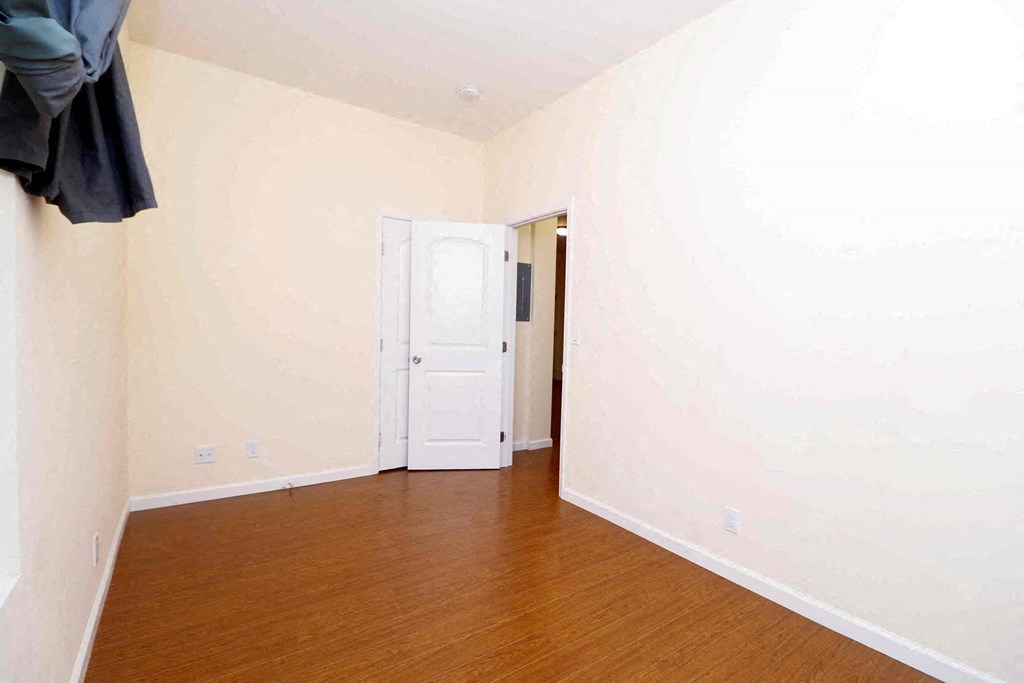 a room with a wooden floor and a white door