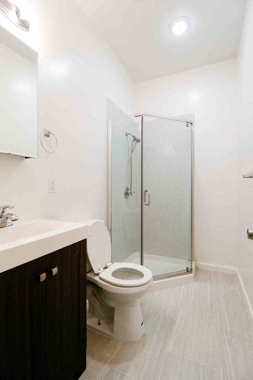 a bathroom with a shower and a toilet and a sink