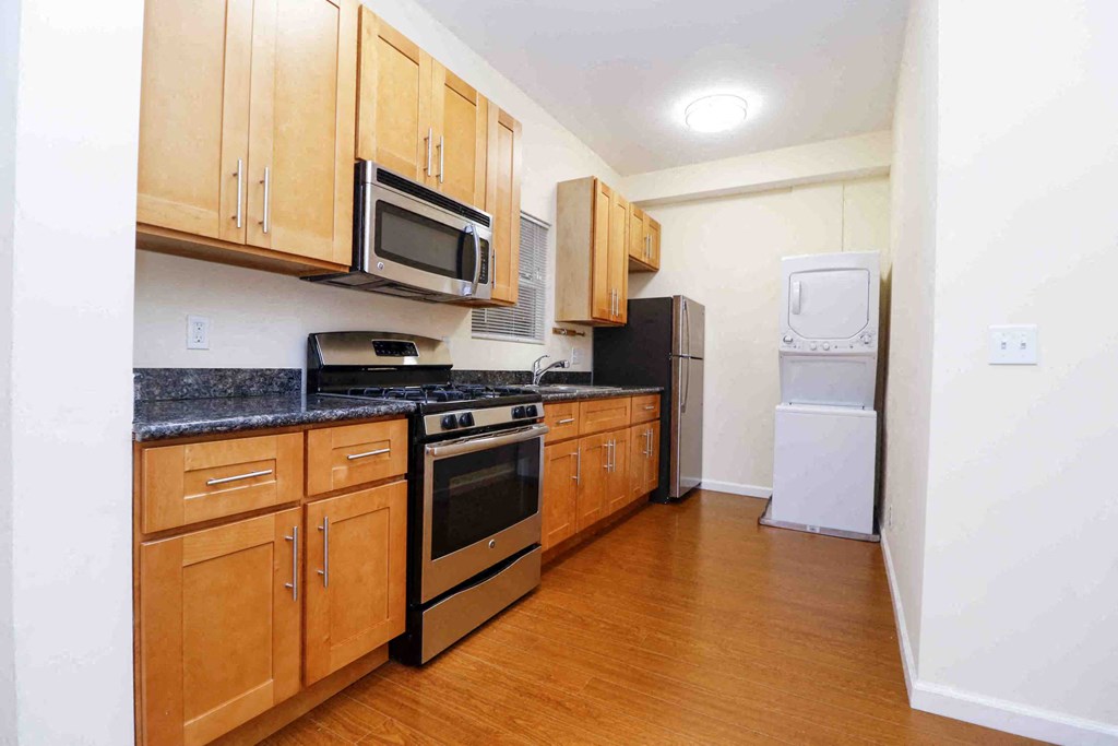 a kitchen with wooden cabinets and stainless steel appliances