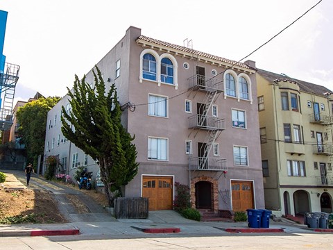 an apartment building on the corner of a street